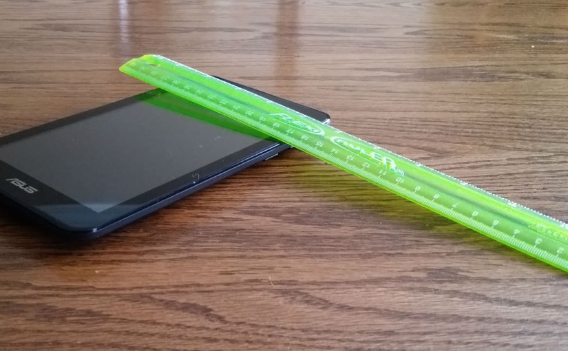 An Asus brand tablet and a ruler